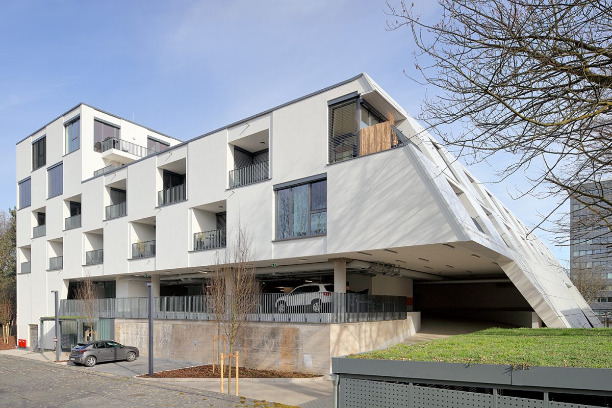 Modernes Wohnhaus mit schräger Fassade und integriertem Garagengeschoss